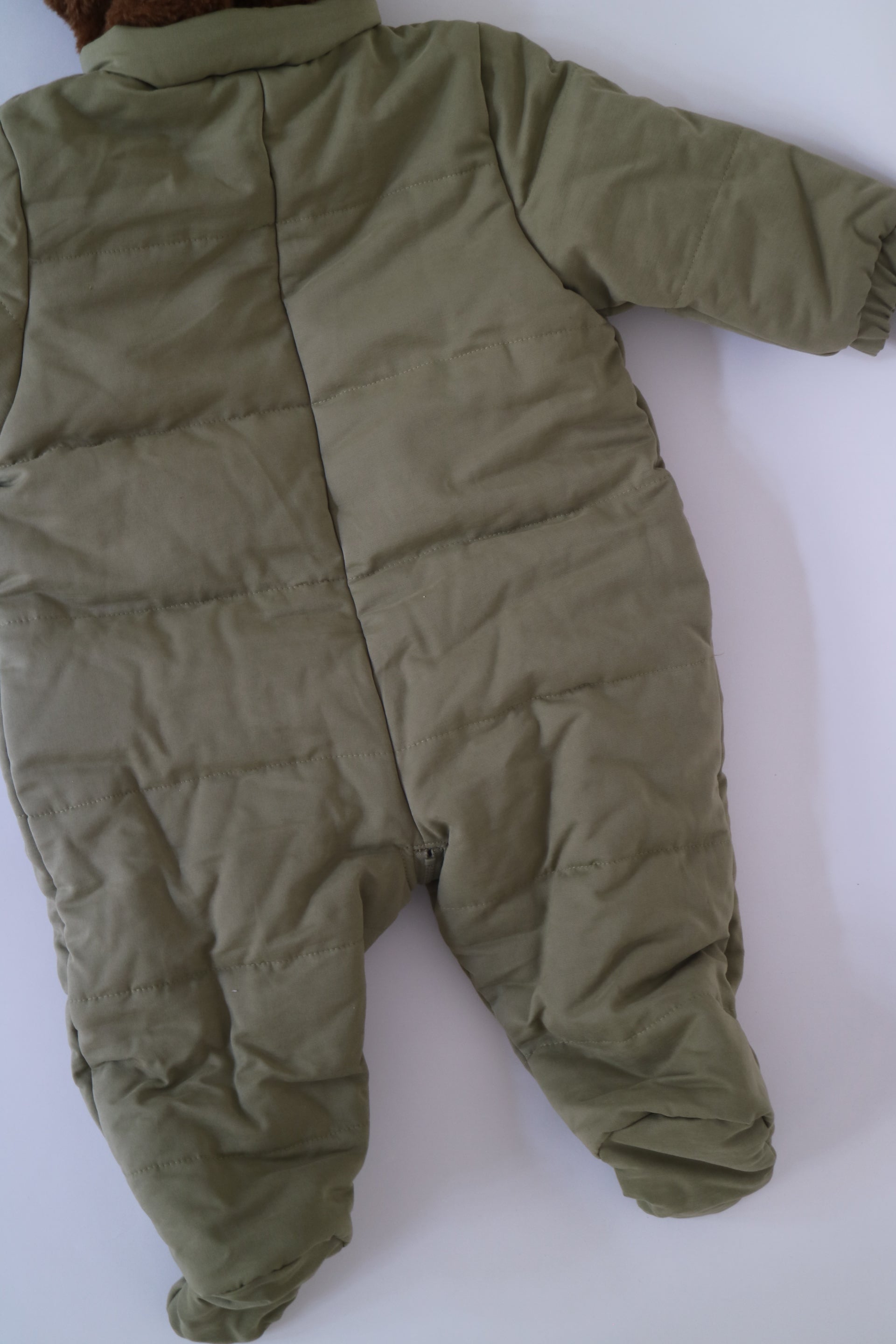 Fodrad overall i ljus militärgrön färg med kornblåa fickor och brun luva i teddy-material från Bobo Choses, modell Face Multicolor Overall. 4